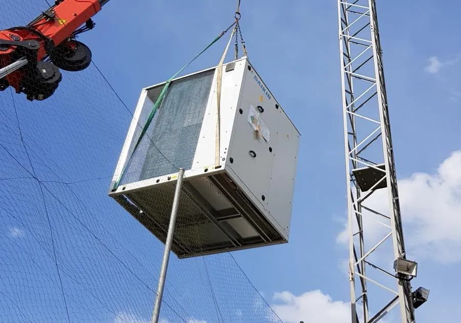 A unit hanging from a crane